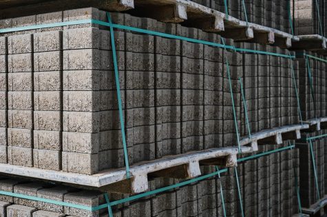 pallets-with-stacked-gray-paving-slabs-selective-focus-stack-paving-slabs-warehouse-road-repair-finished-tile-sale-space-text_166373-3193